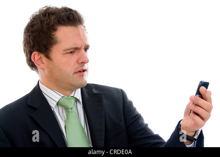 scared businessman looking at his mobile phone Stock Photo