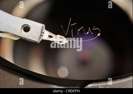 Actuator arm and head of a computer hard drive, with the engraved word 'virus' Stock Photo