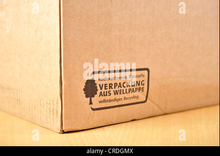 Cardboard box with print 'Verpackung aus Wellpappe, nachwachsende Rohstoffe, vollstaendiges Recyling' or corrugated cardboard Stock Photo
