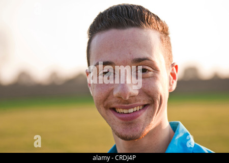 Smiling young man, portrait, on an autumn meadow Stock Photo