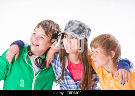 Three friends, one girl and two boys, arm in arm Stock Photo