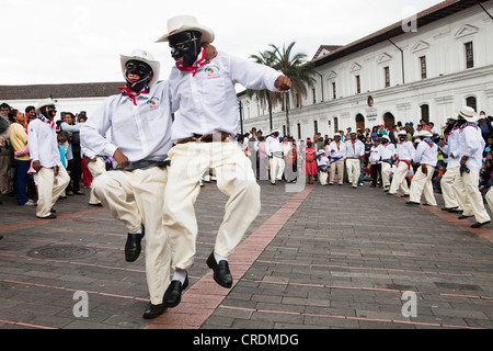 Male dance group on the edge of a procession, car-free Sunday in the historic centre of Quito, Ecuador, South America Stock Photo