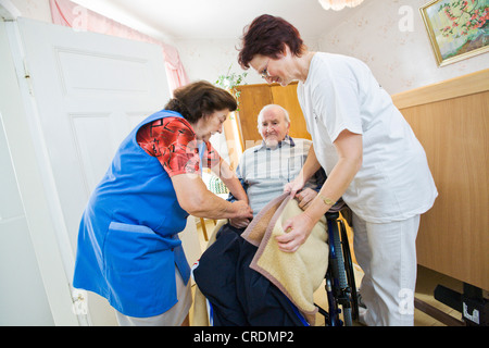 Outpatient care provided by the German Red Cross, nurse Anke Lehmann visits an elderly couple every morning to help the wife of Stock Photo