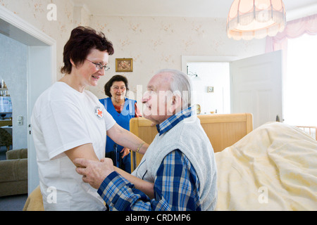 Outpatient care provided by the German Red Cross, nurse Anke Lehmann visits an elderly couple every morning to help the wife of Stock Photo