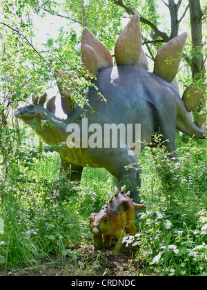 Stegosaurus (Stegosaurus), with young in shrubbery Stock Photo