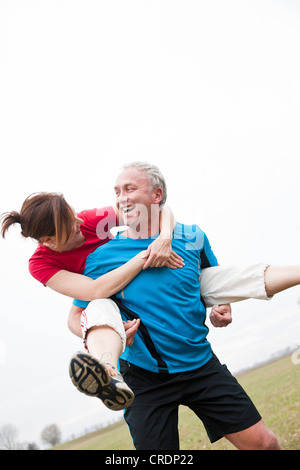 Man carrying a woman on his back Stock Photo