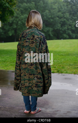 YOUNG GIRL WEARING MILITARY JACKET Stock Photo