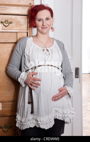 Pregnant woman holding her pregnant belly Stock Photo