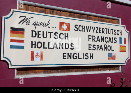 Sign on a multi-lingual shop in Dawson City, Canada, North America, PublicGround Stock Photo