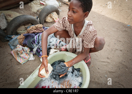 A girl hand washes clothes in the Point Four neighborhood of Monrovia, Montserrado county, Liberia on Thursday April 5, 2012. Stock Photo