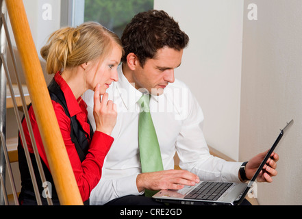 two young business people using laptop Stock Photo