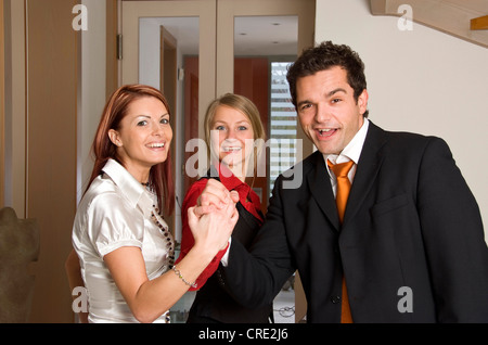 three young successful business people cheering Stock Photo
