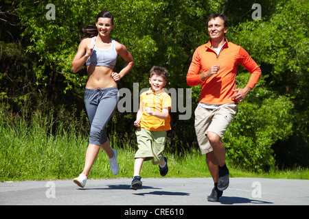 Lovely family jogging in the open air Stock Photo