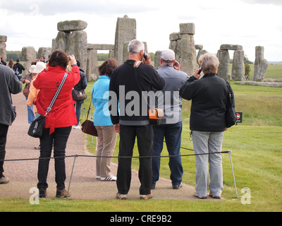Tourists sightseeing and listening to electronic audio guides at Stonehenge, England, May 16, 2012, © Katharine Andriotis Stock Photo