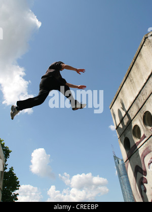 Parkour athlete at a daring jump over obstacles, Austria, Vienna, Donauinsel Stock Photo