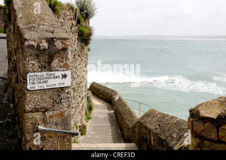 Steps on the sea wall in St Ives Cornwall with a sign showing the way to the Tate gallery Stock Photo