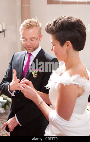 Bride and groom exchanging wedding rings during the church wedding, Regensburg, Bavaria, Germany, Europe Stock Photo