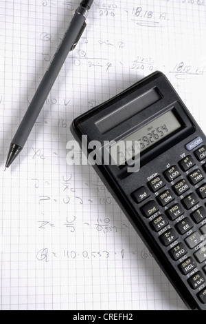 Pen and calculator on math exercises paper Stock Photo