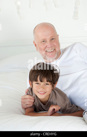 father with son embracing while laying on hospital bed at ward, dad and