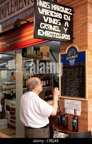 Wine merchants in the market hall, Mercado de Triana, Seville, Andalucia, Spain, Europe Stock Photo