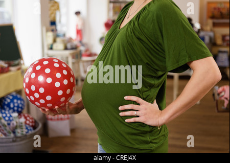 Pregnant woman holding rubber ball Stock Photo