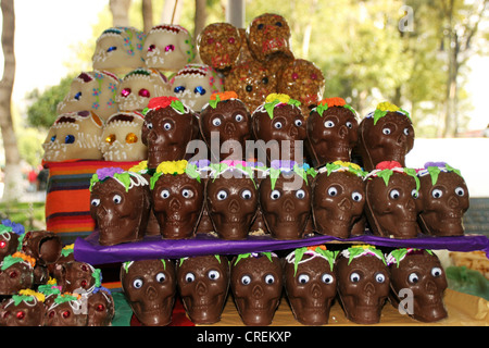 skulls made of sugar and chocolate in a shop window at the day of the death, Mexico, Mexiko Stadt Stock Photo
