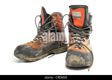 Pair of worn muddy hiking boots Stock Photo