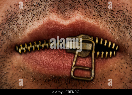 Close up of man's mouth with bronze or gold metal zipper closing lips shut. Stock Photo