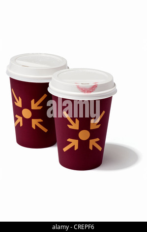 Two takeaway drink cups with meeting point symbol, one with a lipstick mark Stock Photo