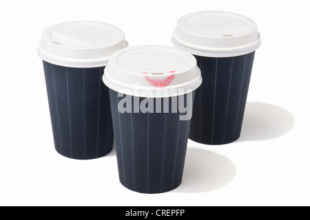 Three takeaway drink cups with pinstripe pattern, one with a lipstick mark Stock Photo