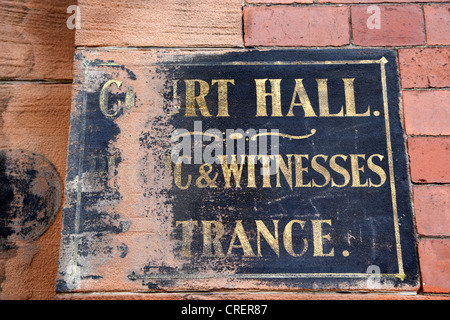 old worn painted sign for court hall public and witnesses entrance on the wall of the old district court glasgow scotland uk Stock Photo