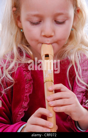 girl playing recorder Stock Photo
