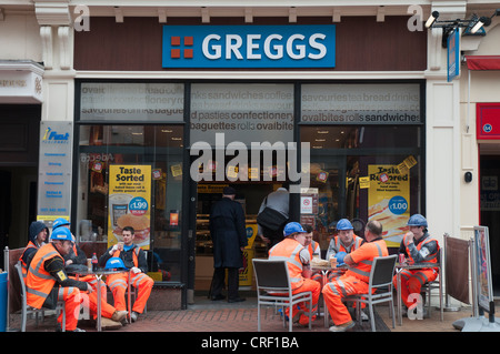 British construction workers wearing safety vests, taking a lunch break in Birmingham Stock Photo