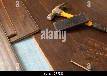 Hammer and Block with New Laminate Flooring Abstract. Stock Photo