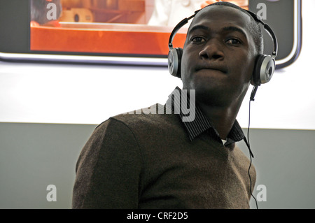 young dark-skinned man with headphones, USA, New York City, Manhattan Stock Photo