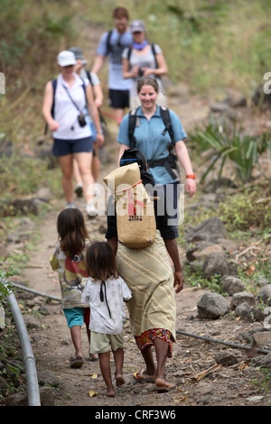 Tourists meeting locals on walking trail. Atauro Island, East Timor. Stock Photo