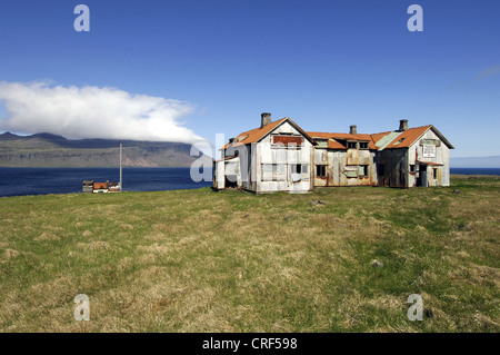 Old abandoned hospital building at the mouth of Faskrudsfjoerdur in the East Fjords region of eastern Iceland, Iceland Stock Photo