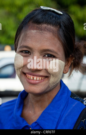 Myanmar, Burma, Yangon. Burmese Woman with Thanaka Paste on Face as a Cosmetic Sunscreen. Stock Photo