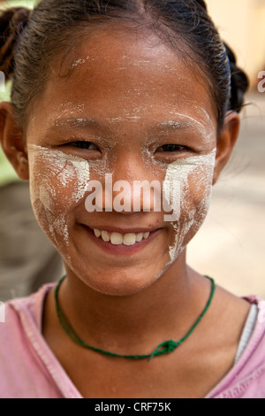 Myanmar, Burma, Yangon. Burmese Woman with Thanaka Paste on Face as a Cosmetic Sunscreen. Stock Photo