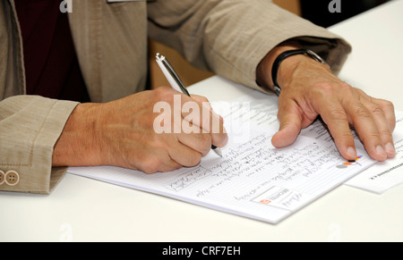 man making notes during presentation Stock Photo