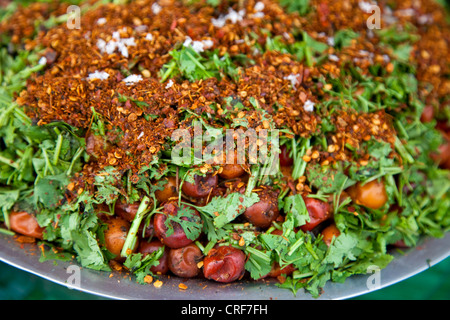 Myanmar, Burma, Yangon. Plums, Peppers, and Greens--a tray of street food offered by a food vendor. Stock Photo