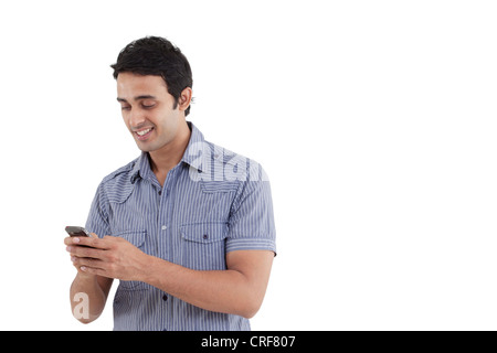 Young man text messaging Stock Photo