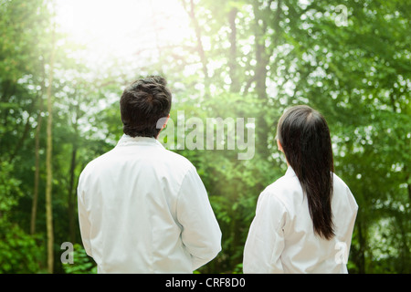 Scientists admiring forest trees Stock Photo