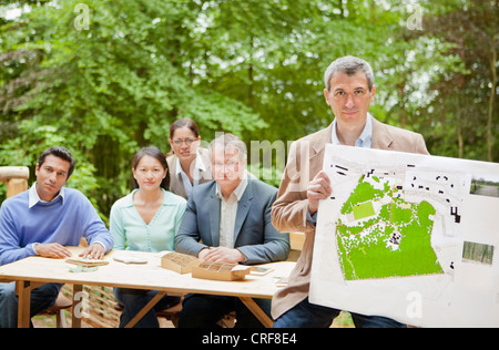 Businessman with map in meeting Stock Photo