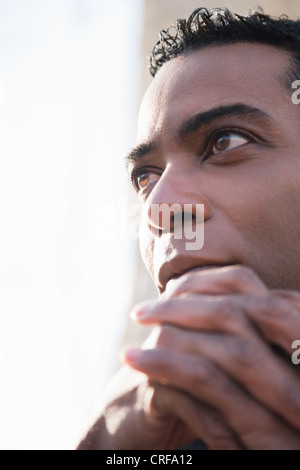Thoughtful African American businessman with hands clasped Stock Photo