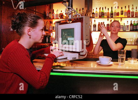 Berlin, Germany, girl surfing the internet at the bar Stock Photo