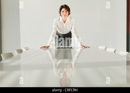 Businesswoman reflected in table Stock Photo