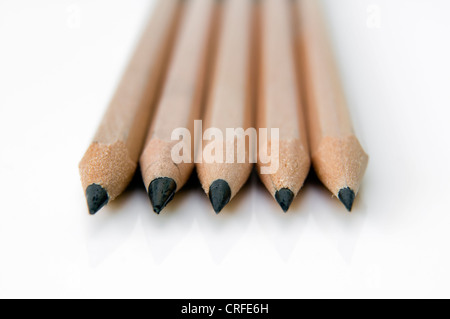 Five sharpened black HB pencils on white background Stock Photo