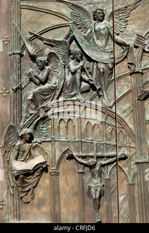 Closeup on ornate door to the Almudena Cathedral in Madrid, Spain, featuring Jesus Christ and Angels. Stock Photo