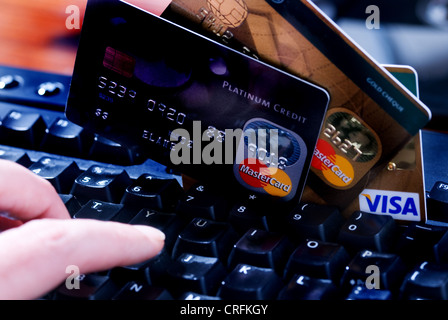 Computer keyboard with hand and credit cards, on line sales. Stock Photo